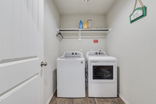 washroom with wood-type flooring and washer and clothes dryer