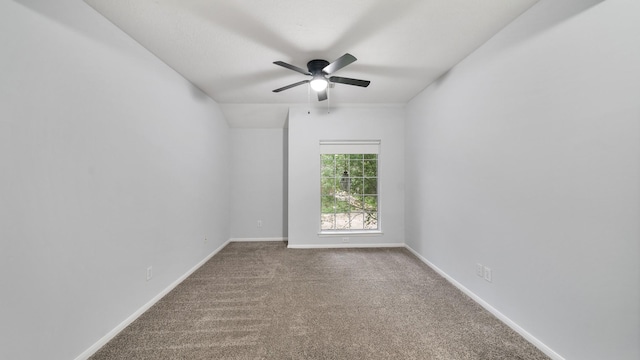 unfurnished room featuring ceiling fan, carpet floors, and vaulted ceiling