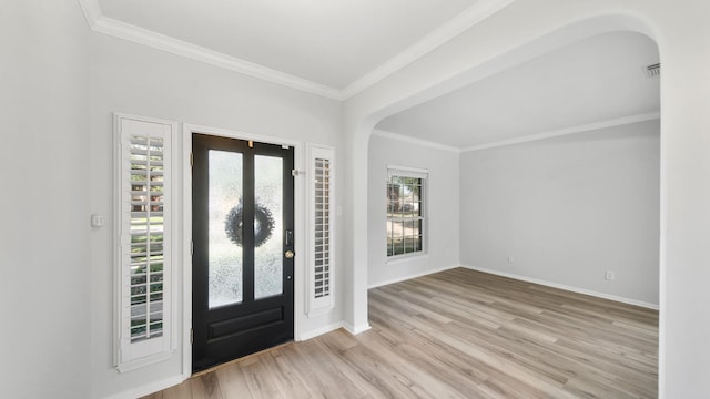 foyer featuring light wood-type flooring and crown molding