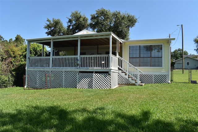 back of house featuring a yard