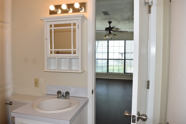 bathroom with wood-type flooring, vanity, and ceiling fan