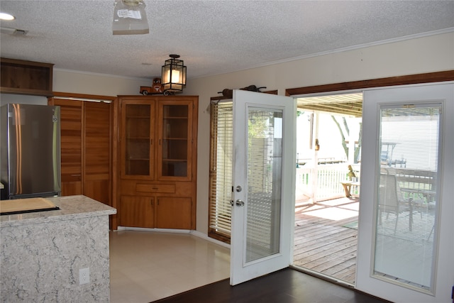 interior space featuring a textured ceiling and ornamental molding