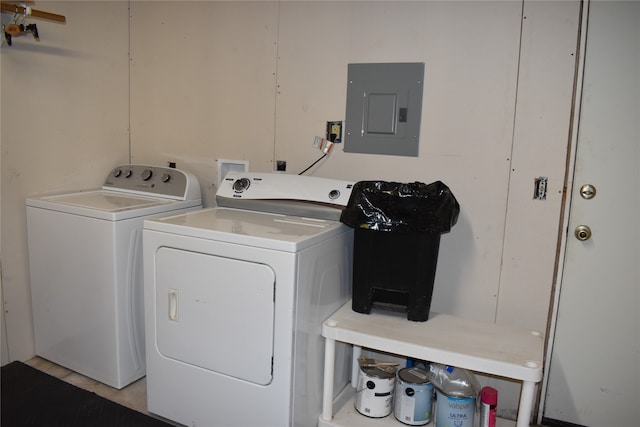 laundry room featuring electric panel and washing machine and clothes dryer