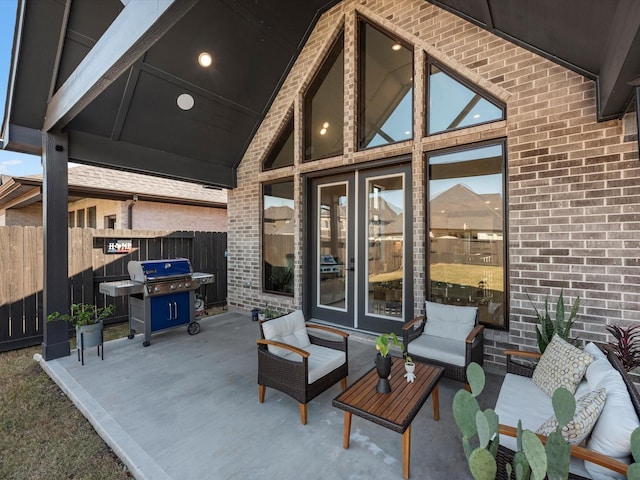 view of patio with grilling area, an outdoor living space, and french doors