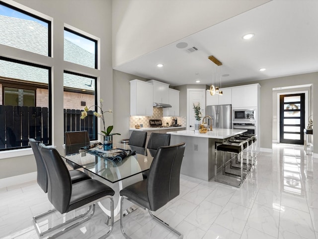 dining room with a wealth of natural light and sink