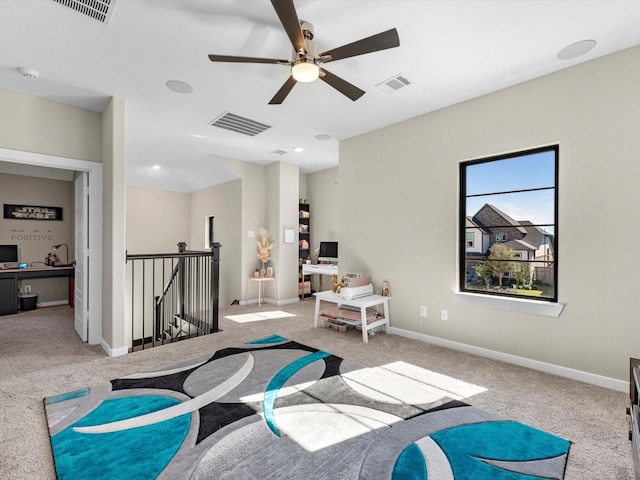 living area featuring ceiling fan and light colored carpet