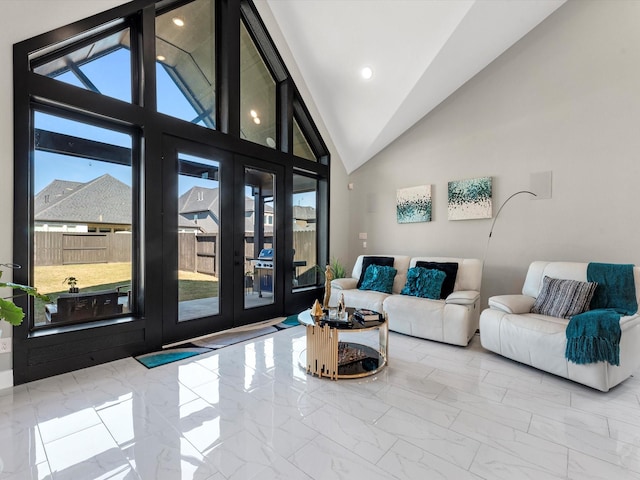 living room with a healthy amount of sunlight and high vaulted ceiling