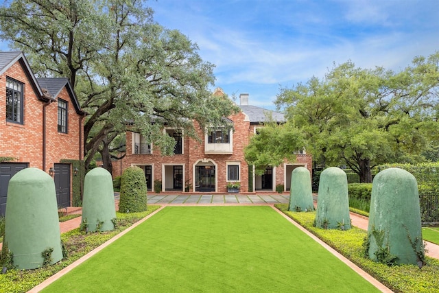 rear view of house featuring a yard