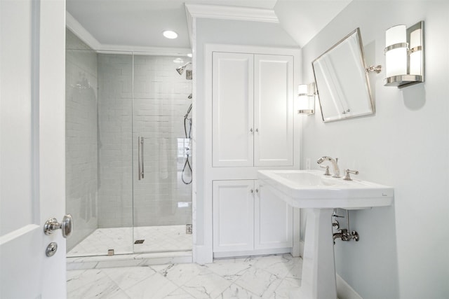 bathroom with a shower with shower door and crown molding