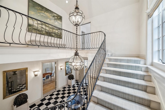 staircase featuring a chandelier