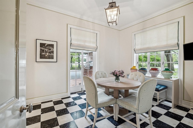 dining space featuring a healthy amount of sunlight and ornamental molding