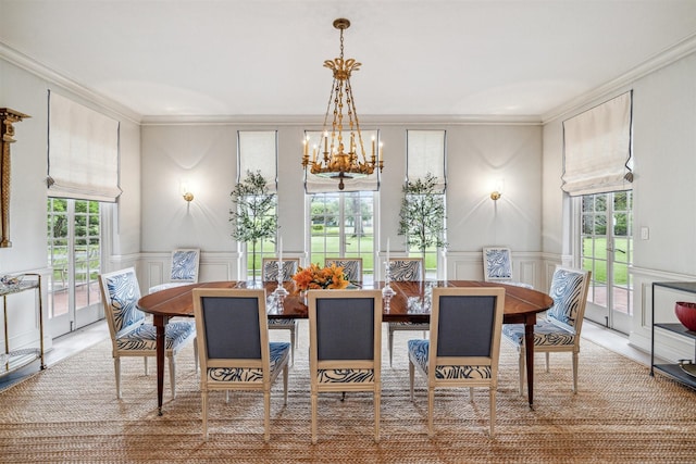 dining area with a notable chandelier and crown molding