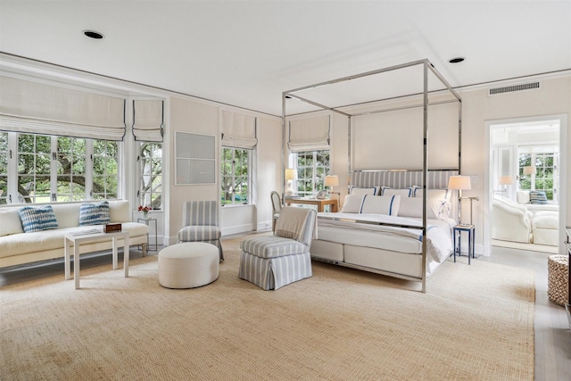 bedroom with multiple windows and carpet floors