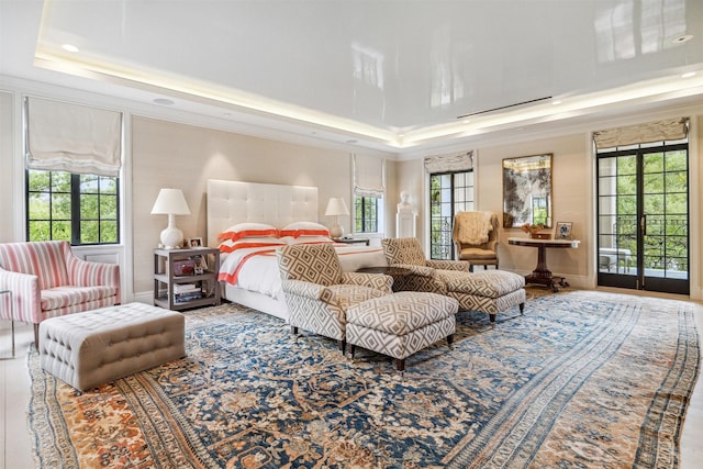 bedroom with a tray ceiling and ornamental molding