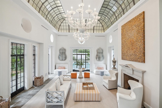 living room with french doors, a high ceiling, and an inviting chandelier