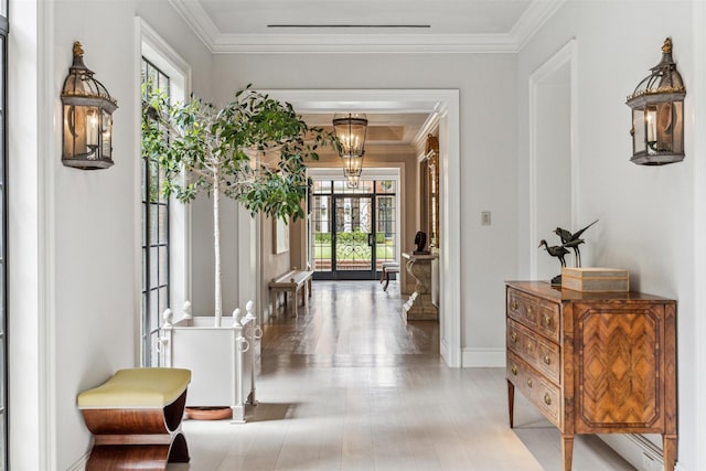 hallway with french doors, plenty of natural light, and crown molding