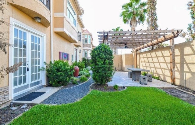 view of yard with a pergola, a patio, and french doors