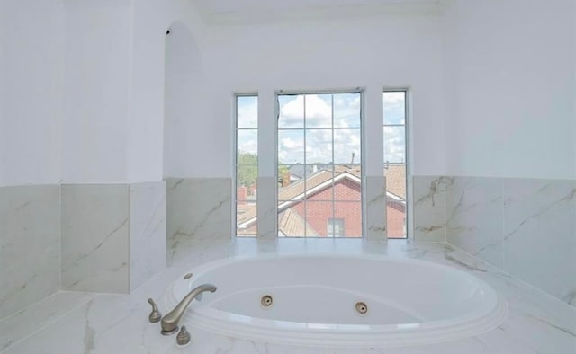 bathroom featuring a relaxing tiled tub