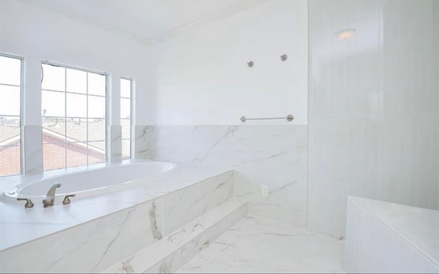 bathroom featuring a relaxing tiled tub