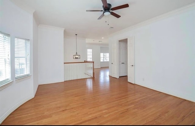 unfurnished living room with light wood-type flooring, ceiling fan, and ornamental molding