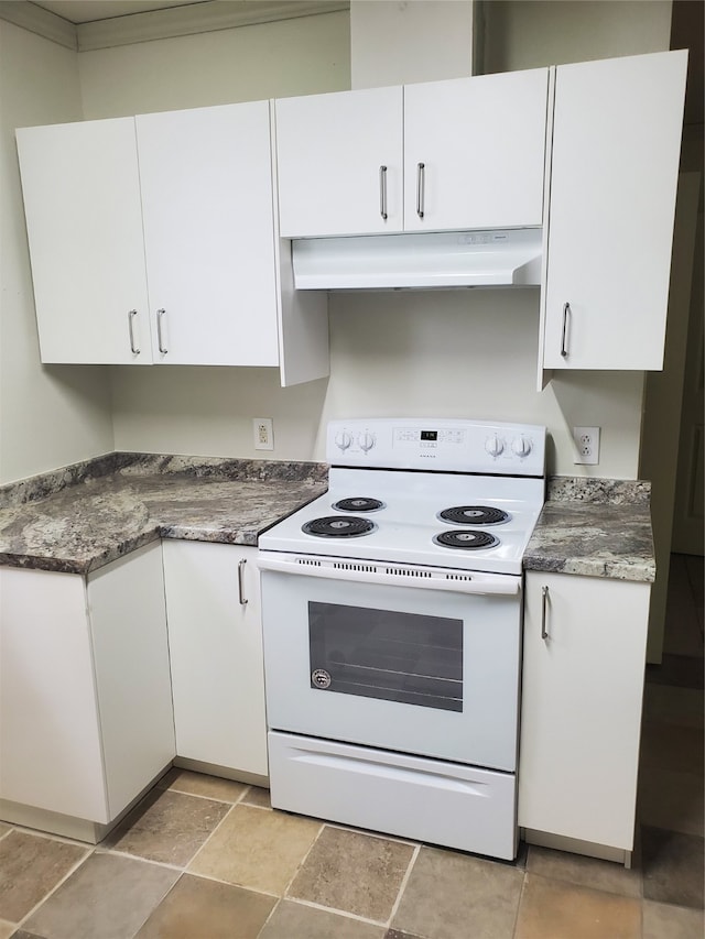 kitchen with dark stone countertops, white cabinets, and white electric stove