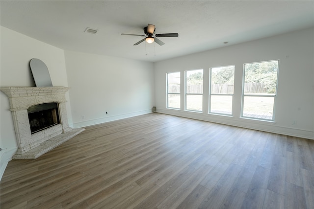 unfurnished living room with hardwood / wood-style floors and ceiling fan