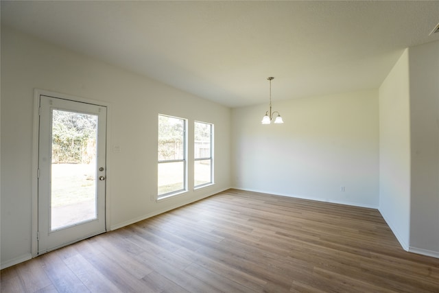 interior space featuring hardwood / wood-style flooring and a chandelier