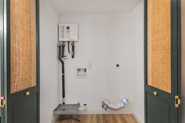 laundry room featuring washer hookup, light hardwood / wood-style floors, hookup for a gas dryer, and electric dryer hookup