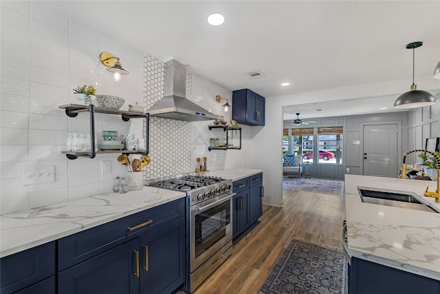 kitchen featuring high end stainless steel range, dark hardwood / wood-style flooring, sink, wall chimney range hood, and blue cabinets