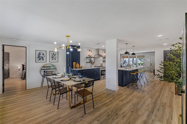 dining room featuring a notable chandelier and light hardwood / wood-style flooring