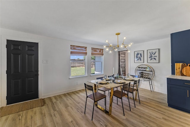 dining area featuring light wood-type flooring and a chandelier