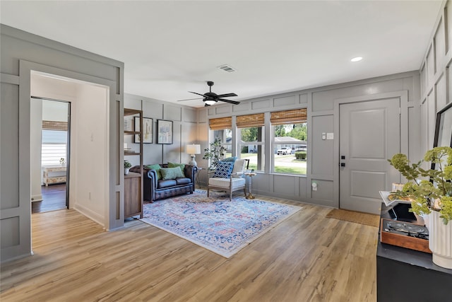 living room featuring ceiling fan and light wood-type flooring