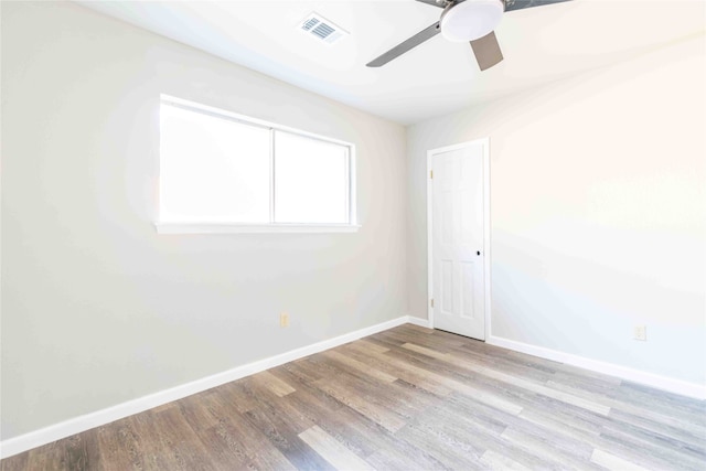 spare room featuring light wood-type flooring and ceiling fan