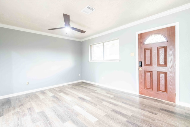 foyer entrance featuring ceiling fan, ornamental molding, and light hardwood / wood-style flooring