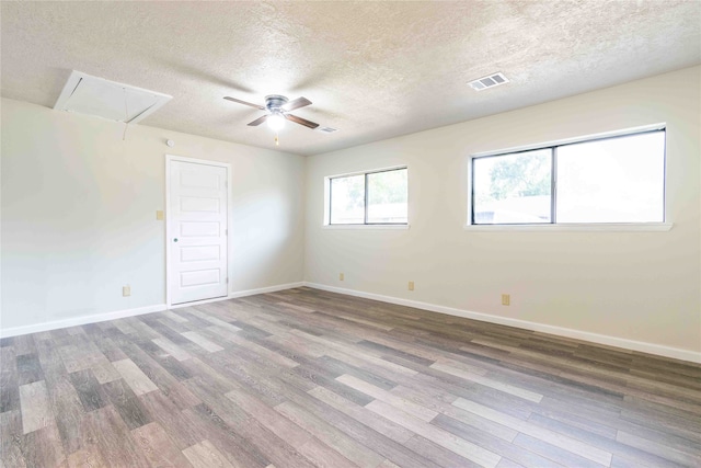 spare room with a textured ceiling, ceiling fan, and wood-type flooring