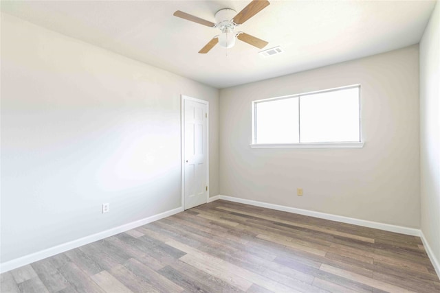 spare room with wood-type flooring and ceiling fan