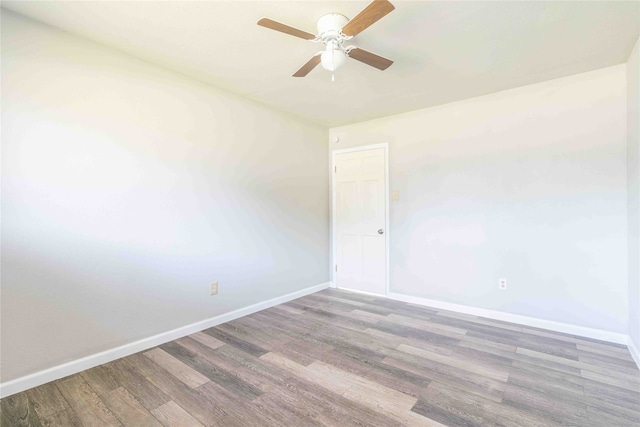 empty room with hardwood / wood-style floors and ceiling fan