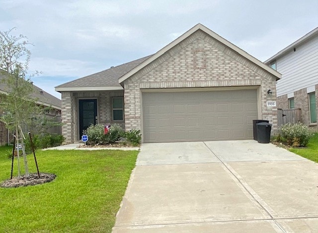 ranch-style home with a garage and a front yard