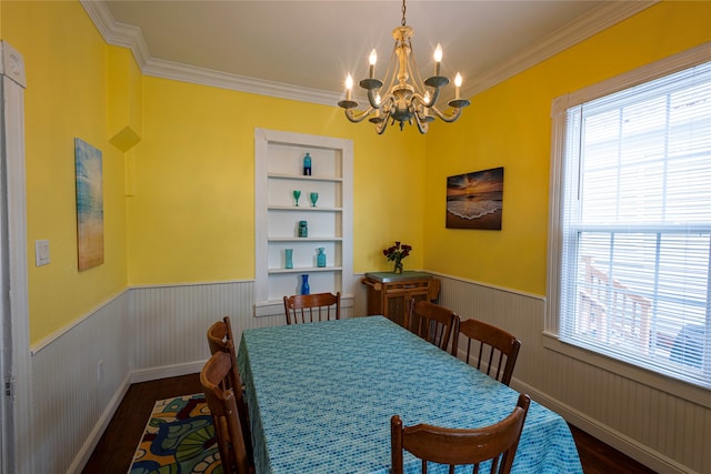 dining space with a notable chandelier, dark hardwood / wood-style flooring, and crown molding