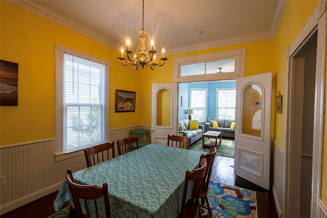 dining space featuring dark hardwood / wood-style floors, an inviting chandelier, and a healthy amount of sunlight