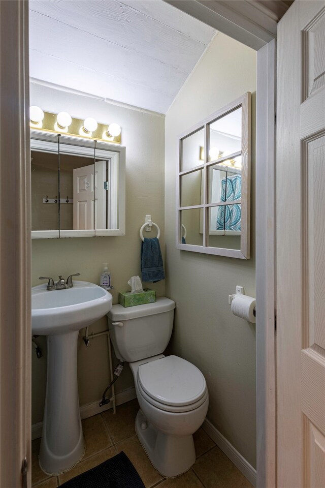 bathroom featuring vaulted ceiling, toilet, and tile patterned flooring