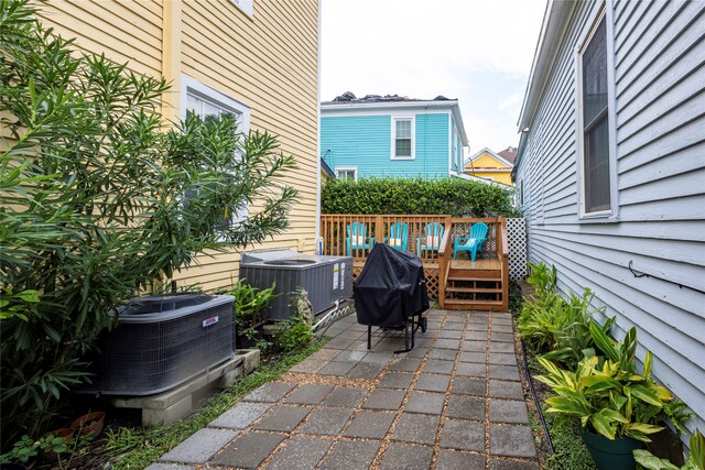 view of patio featuring a grill, central AC unit, and a deck