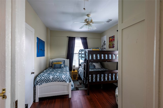 bedroom with ceiling fan and dark hardwood / wood-style flooring