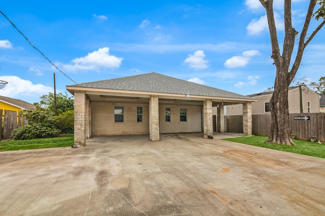 back of house with a lawn and a carport