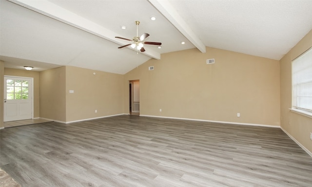 interior space with ceiling fan, light wood-type flooring, and lofted ceiling with beams