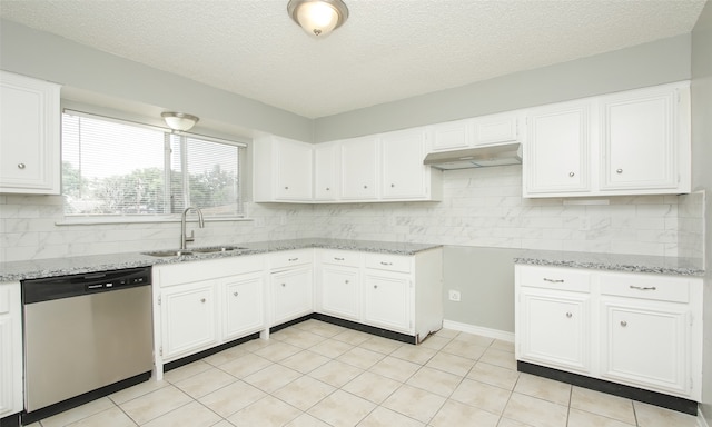 kitchen with dishwasher, light tile patterned floors, white cabinetry, and sink