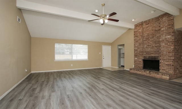 unfurnished living room with hardwood / wood-style flooring, a brick fireplace, ceiling fan, high vaulted ceiling, and beam ceiling