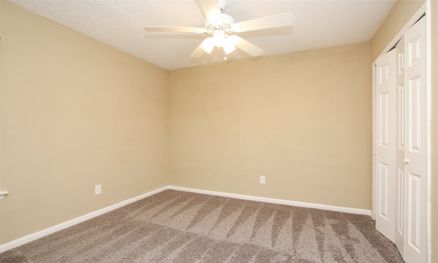 interior space with a textured ceiling, carpet flooring, and ceiling fan