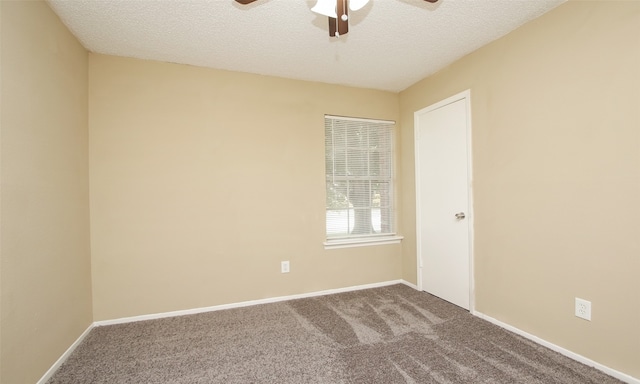 unfurnished room featuring a textured ceiling, ceiling fan, and carpet floors