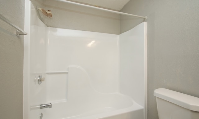 bathroom featuring toilet and shower / washtub combination